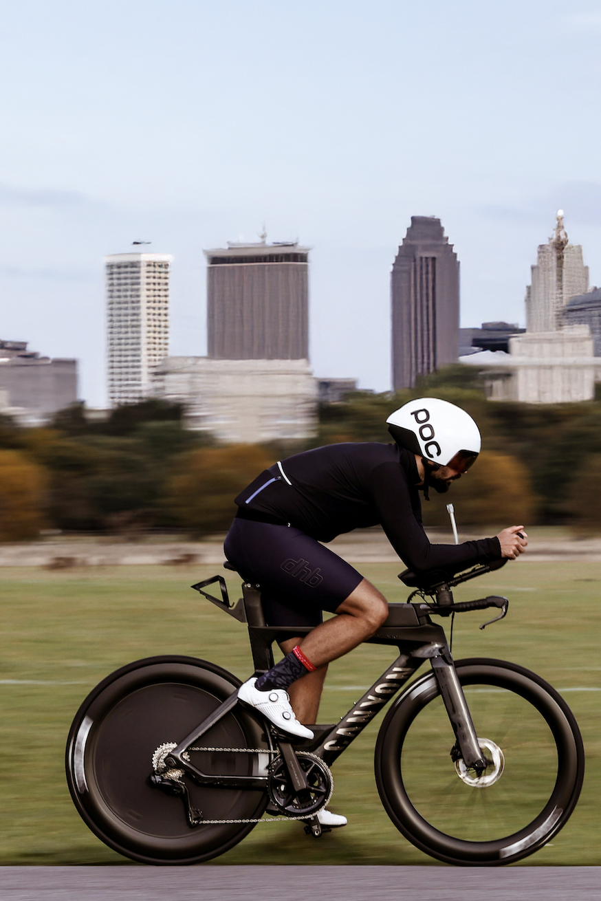 A triathlete begins cycling on a triathlon bike.